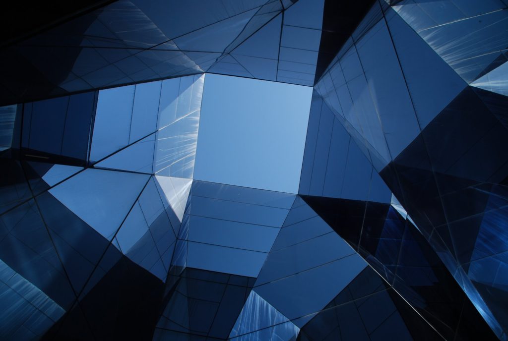 Abstract geometric shapes with blue sky above.